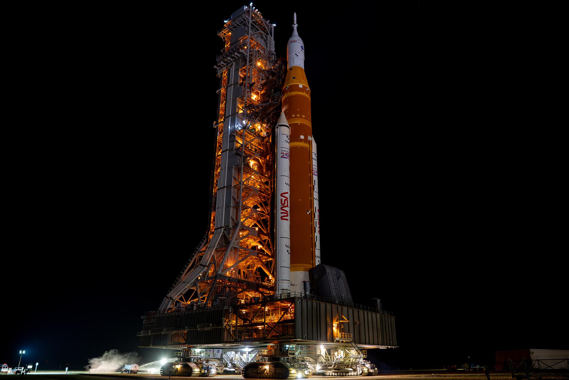 This image shows NASA’s SLS (Space Launch System) and Orion spacecraft rolling out of the Vehicle Assembly Building at NASA’s Kennedy Space Center. NASA's massive Crawler-Transporter, upgraded for the Artemis program, carries the powerful SLS rocket and Orion spacecraft on the Mobile Launcher from the Vehicle Assembly Building to Launch Pad 39B at Kennedy Space Center in preparation for the Artemis II mission. 